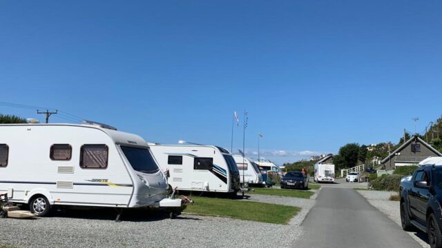 Row of caravans on a bright blue sky day